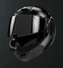 A black motorcycle helmet is shown against a dark gray background. Voir les images du produit