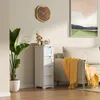 A narrow white cabinet with four drawers stands next to a sofa with a yellow throw blanket. Produktbild-Vorschau