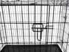 Close-up view of the interior of a black metal pet cage, showing the bars and a latch mechanism. Voir les images du produit