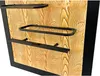 A close-up view of a black metal wine rack mounted on a wood-textured panel. Produktbild-Vorschau