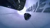 A person in a helmet and goggles is sliding down an icy track in a bobsled or luge. Náhled obrázku produktu