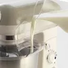 Milk being poured into a kitchen mixer. Náhled obrázku produktu