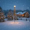 A snowy scene with a decorated Christmas tree and a log cabin in the background. Podgląd zdjęcia produktu