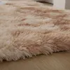 A close-up view of a fluffy, beige rug with brown accents, lying on a wooden floor. Náhled obrázku produktu
