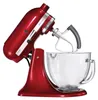 A red KitchenAid stand mixer with a glass bowl and a beater attachment, photographed against a white background. Produktbild-Vorschau