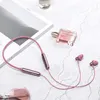 A flat lay of rose pink in-ear headphones, a perfume bottle, and a magazine on a textured surface. Produktbild-Vorschau