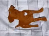 A rusty metal silhouette of a dog with a heart cut out of its side, lying on a striped white and gray surface. Produktbild-Vorschau