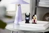Two LEGO BrickHeadz figures, Maleficent and Cruella de Vil, stand on a stack of white books next to a lavender lamp. Anteprima dell’immagine prodotto