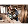 A man is using a belt sander on a large wooden beam in a rustic workshop. Podgląd zdjęcia produktu