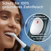 A woman is brushing her teeth with an electric toothbrush, with a close-up inset showing the toothbrush's pressure sensor feature. Produktbild-Vorschau