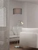 A floor lamp with a flexible reading light is shown in a living room setting. Náhľad obrázku produktu