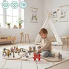 A baby playing with a wooden train set in a child's room. Podgląd zdjęcia produktu