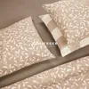 A close-up view of bedding with a leaf pattern. Produktbild-Vorschau
