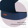 Close-up of a baby carrier with a patterned fabric and a label. Náhled obrázku produktu