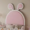 A close-up view of a pink and white bed headboard with bunny ears. Anteprima dell’immagine prodotto