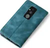 A teal-colored flip case for a smartphone is shown from a diagonal top-down view on a white background. The camera module of the phone is visible through the case. Produktbild-Vorschau