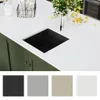 A kitchen sink and countertop with decorative elements. Produktbild-Vorschau