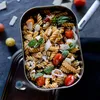 A close-up view of a lunchbox filled with pasta, cherry tomatoes, basil, and shaved cheese. Podgląd zdjęcia produktu