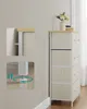 A tall, narrow storage dresser with five beige fabric drawers and a wooden top is shown in a room with a light gray wall and white baseboard. An inset shows a close-up of the adjustable foot of the dresser, with arrows indicating up and down movement and a Náhled obrázku produktu