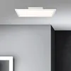 A modern LED ceiling light fixture mounted on a gray ceiling, with gray and black walls in the background. Produktbild-Vorschau