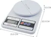 A white digital kitchen scale with dimensions indicated. Voir les images du produit