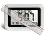 A digital clock with a ruler placed diagonally across its screen. Voir les images du produit