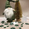 A Christmas gnome and tree decoration with scattered stars on a patterned background. Produktbild-Vorschau