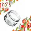 A glass jar is shown tilted on a white background, surrounded by various fresh vegetables and herbs. Produktbild-Vorschau