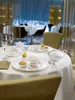 A beautifully set table in a restaurant with fine china and cutlery, ready for a meal. Náhľad obrázku produktu