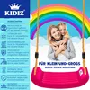 A mother and daughter are smiling and hugging on a swing set with a rainbow in the background. Produktbild-Vorschau