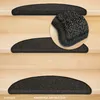 Several dark gray, semi-circular stair mats are placed on light wooden stairs. A close-up inset shows the texture of one of the mats. Produktbild-Vorschau