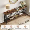 A long, narrow console table with a rustic wood finish and black metal frame, decorated with a lamp, books, a small deer figurine, a basket, and a vase with flowers. Náhľad obrázku produktu