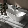 A modern bathroom with a freestanding bathtub, plants, and wooden wall paneling. Produktbild-Vorschau