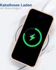 A smartphone is placed on a wireless charger, displaying a charging animation. Produktbild-Vorschau