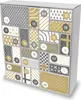 A close-up, angled view of a white cardboard advent calendar with various numbered boxes decorated with different patterns in gold and gray. Produktbild-Vorschau