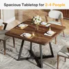 A square wooden dining table set for four people in a dining room. Náhled obrázku produktu