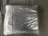 A product wrapped in plastic, likely a replacement awning fabric, lying on a gray surface. Produktbild-Vorschau