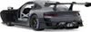 A gray Porsche 911 GT2 RS Clubsport 25 model car with its driver's side door open, shown from a rear-quarter angle against a white background. Podgląd zdjęcia produktu