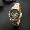 A gold Maserati chronograph watch with a black face is displayed on a black textured surface, with a pair of sunglasses partially visible in the upper left corner. Náhled obrázku produktu