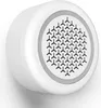 A white, circular smart alarm siren is mounted on a white wall. Produktbild-Vorschau