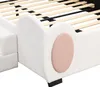 A close-up view of the side of a white bed frame with a pink oval accent. Podgląd zdjęcia produktu