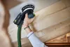 A person is using a Festool sander on a wooden ceiling. Voir les images du produit