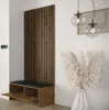 A modern entryway with a wooden slatted panel, a bench with storage, and decorative pampas grass in a vase. Náhled obrázku produktu