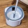 A spin mop and bucket set on a wooden floor. Podgląd zdjęcia produktu