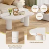 A white coffee table with unique cloud-like shape and cylindrical legs, shown in a living room setting with decorative elements and text overlays highlighting its features. Produktbild-Vorschau