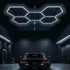 A black car is parked in a dark garage with hexagonal LED lights on the ceiling. Náhled obrázku produktu