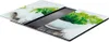 A set of two glass cutting boards with a nature-themed print, placed on a dark surface. Anteprima dell’immagine prodotto