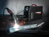 A welding machine is shown in operation, creating sparks as it welds metal. Produktbild-Vorschau