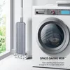 A mop is shown standing next to a washing machine in a room with a window. Podgląd zdjęcia produktu