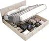 A bed with its storage compartment open, revealing various items stored inside. Voir les images du produit